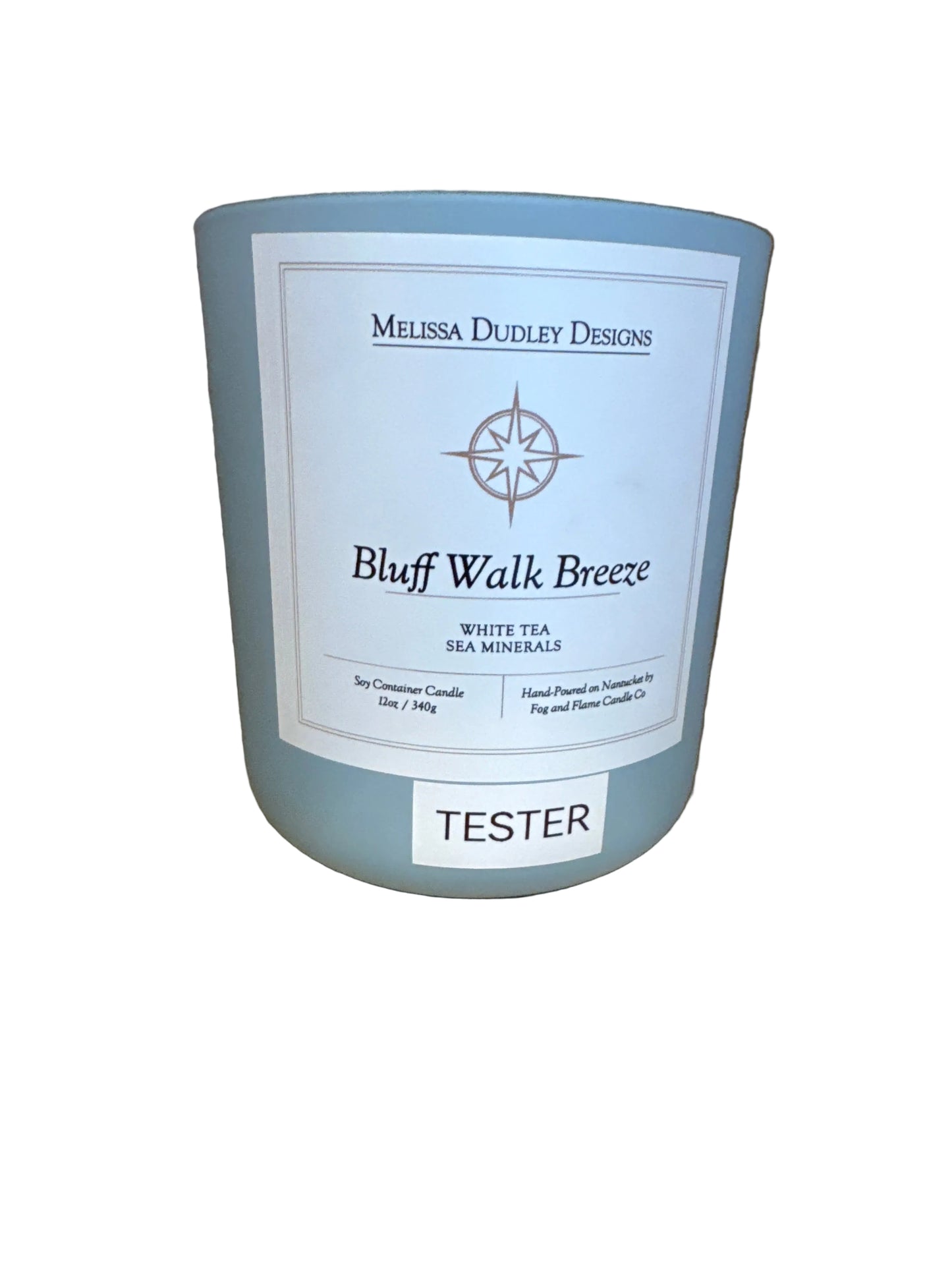 Candle with a label on a wooden surface