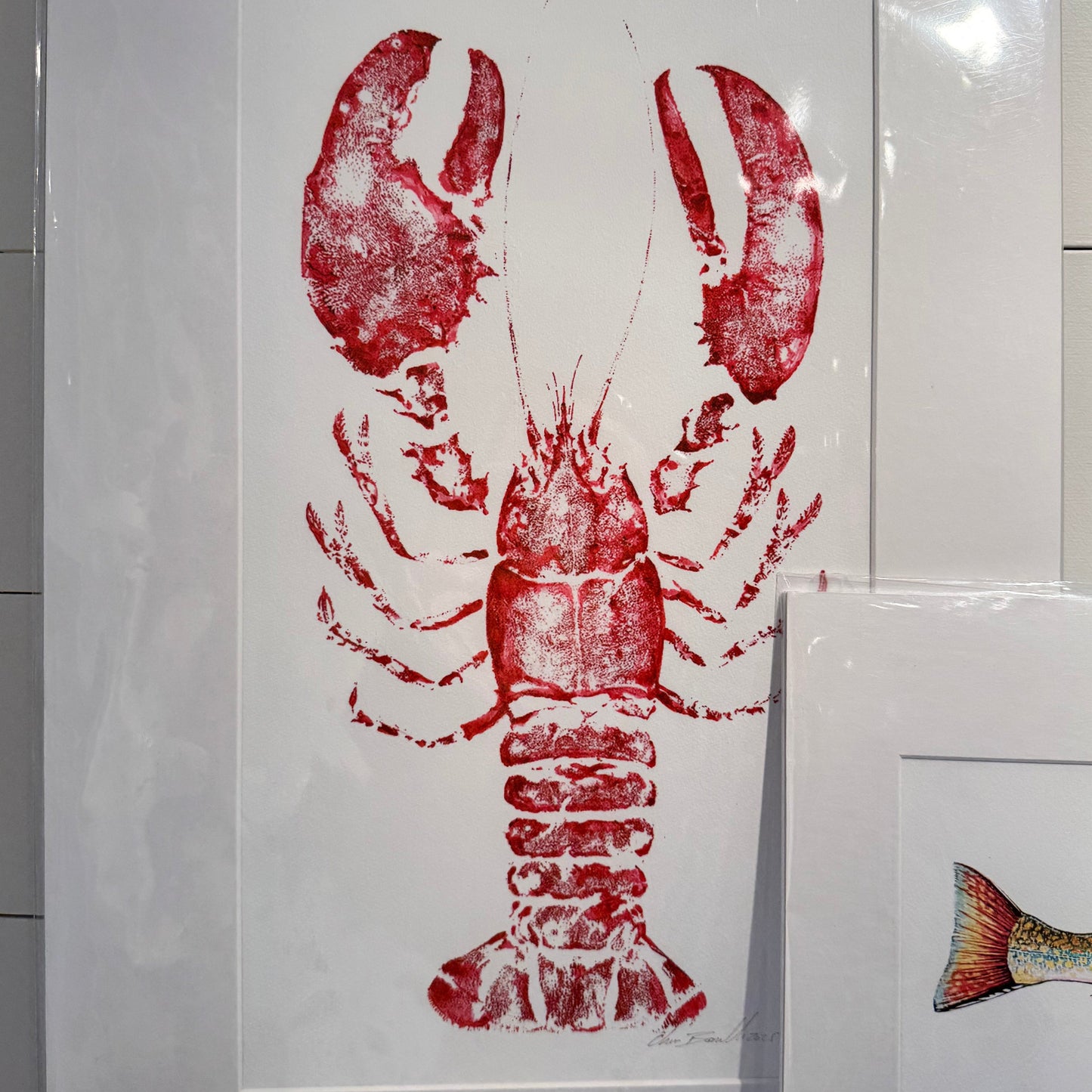 Framed artwork of a red lobster on a white background